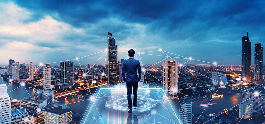 Businessman walks forward on a futuristic bridge in front of a city skyline.