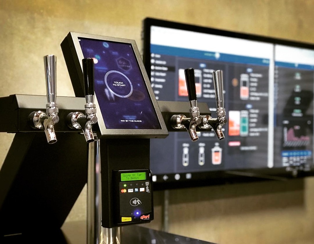 A kegerator vending machine with a Cantaloupe card reader.