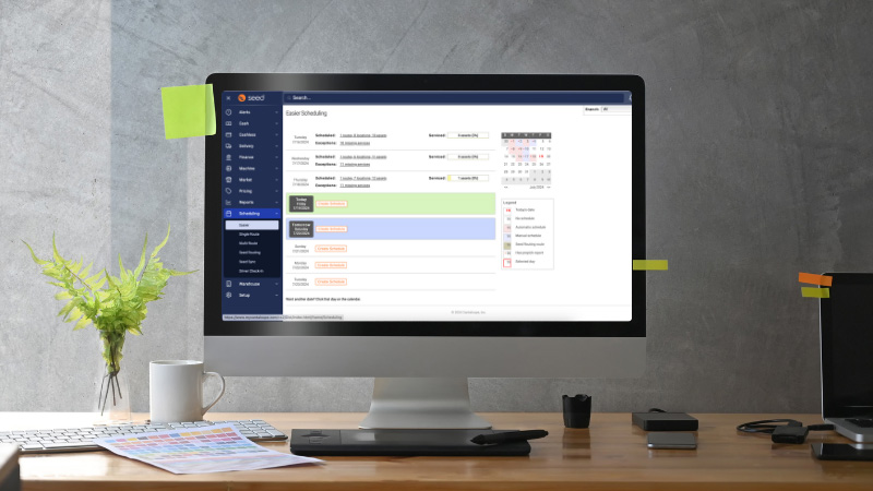 A desktop computer with the Seed Pro scheduling web page.