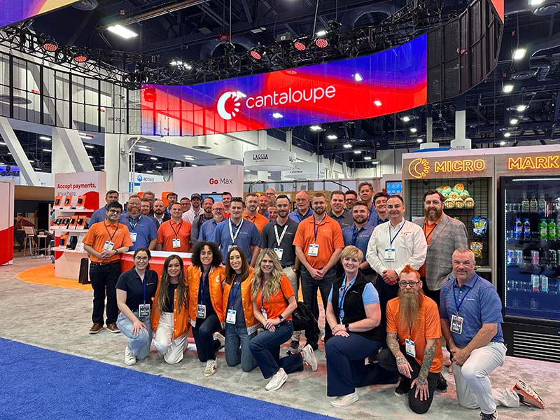The Cantaloupe crew poses in front of the Cantaloupe booth at the NAMA 2025 show
